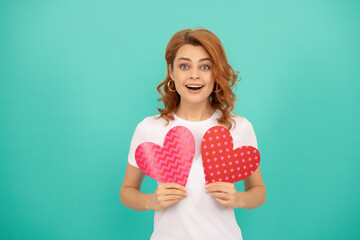 surprised young lady with red heart on blue background