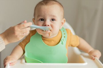 Baby being fed with a spoon of baby food