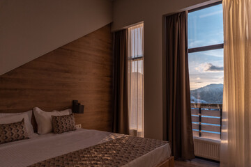 beautiful view from hotel room window at winter mountain at ski resort, sunset