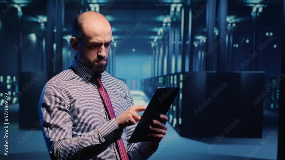 Poster data center it engineer standing in server room with rack cabinets, inspecting cloud computing big d