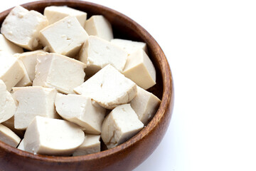 White tofu in wooden bowl on white background.