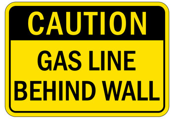 Pipeline sign and labels gas line behind wall