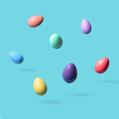 Colorful eggs levitating on pastel light blue background. Creative Easter concept.