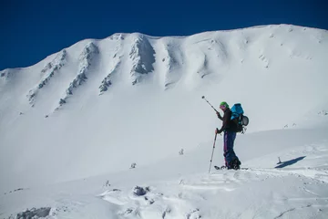 Fotobehang Ski touring in mountains, winter freeride extreme sport. Skiing in the snowy mountains © almostfuture