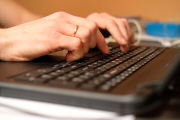 Image of man's hands typing. Selective focus