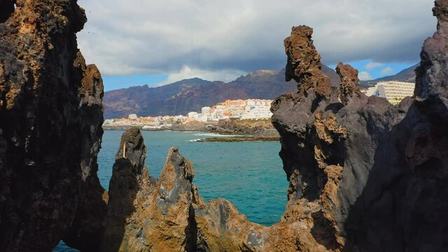 Tenerife, Canary Island Charco El Diablo. Natural pool of Devil. View of black lava flows, volcanic bizzare stones, rocky volcanic beach, Atlantic Ocean.
