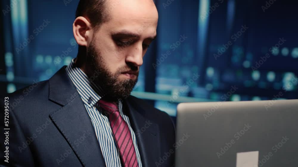 Poster male professional server it engineer using laptop in data center, working on computer mainframe proc