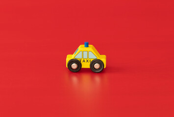 Wood toy for kids: ambulance  isolated on red background. Service for people.