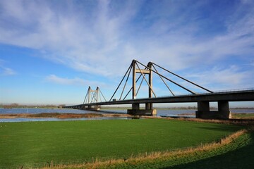 Bridge with motorway the Willem Alexander bridge over the river Maas built on pillars and...