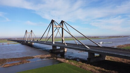Bridge with motorway the Willem Alexander bridge over the river Maas built on pillars and...