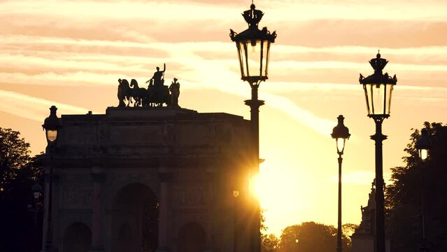 Triumphal Arch of the Carousel, next to the Louvre museum and the pyramid at sunset. Famous historical art landmark in Europe.