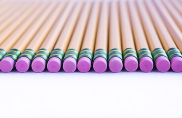 Naklejka premium Lined graphite pencils with eraser on white background. School Stationery supplies.