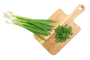 Wooden board with green spring onions on white background, top view