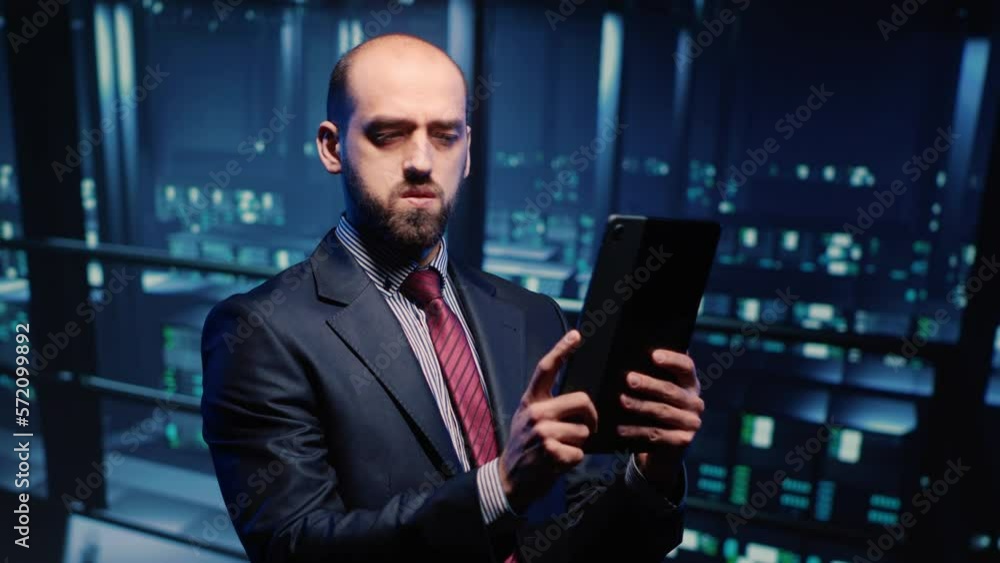 Poster datacenter engineer looking at mainframe diagnostics using digital tablet, inspecting cloud computin