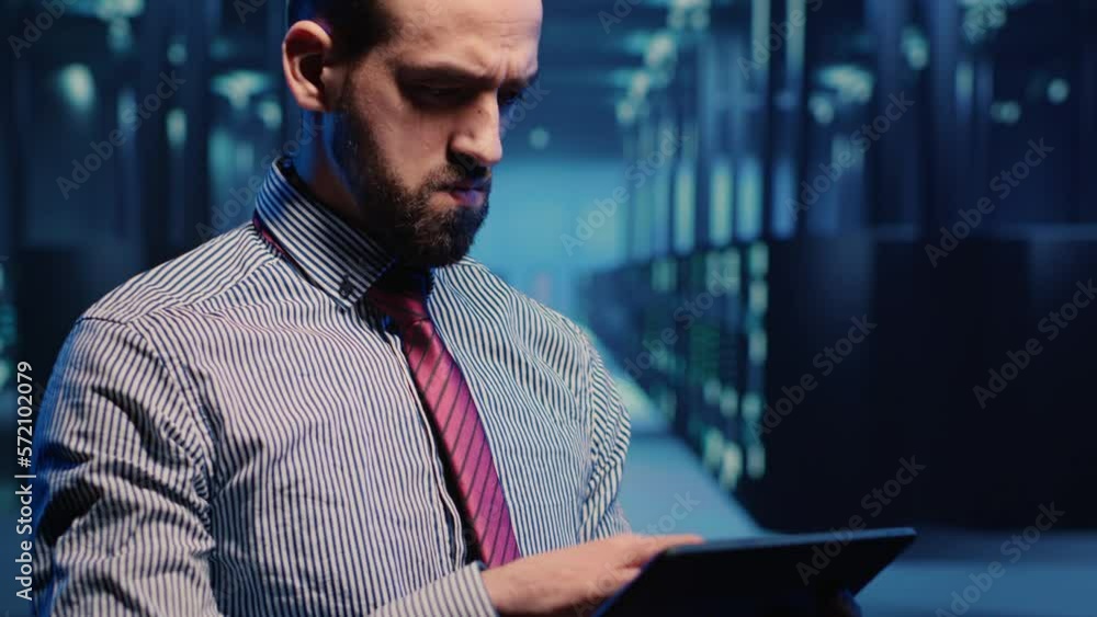 Poster data center it engineer standing next to server cabinets, activating hardware server system on digit