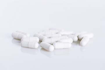 White capsules on white