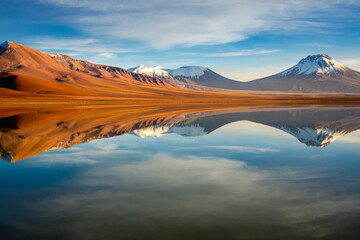 Fototapeta na wymiar Salt lake Lejia reflection, idyllic volcanic landscape at Sunset, Atacama, Chile