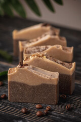 Pieces of fragrant coffee and chocolate soap on the wooden table. Concept of natural eco soap and cosmetics