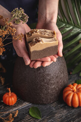 Hands carefully hold a pieces of beautiful fragrant natural soap. Concept of using eco soap and cosmetics and interesting hobby