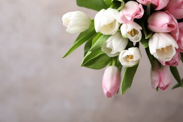 Beautiful bouquet of tulips against beige background. Space for text