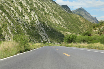 Fototapeta premium Beautiful view of empty asphalt highway near mountains outdoors. Road trip