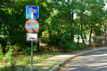 Road signs No Stopping and Dead End outdoors near trees on sunny day, space for text