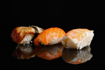 Delicious nigiri sushi on black background. Traditional Japanese cuisine