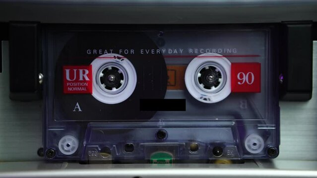 Transparent Audio Cassette Tape Rolling in Deck Player From Beginning, Close Up