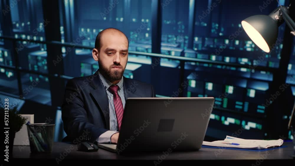 Poster server technician specialist working on laptop running networking diagnostics on cyber security rack