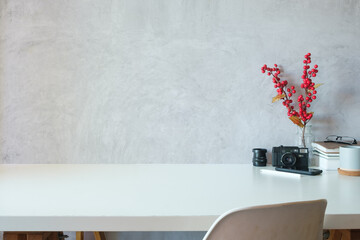 Home office desk with camera books, cup of coffee and smart phone on white table. Copy space for your text.