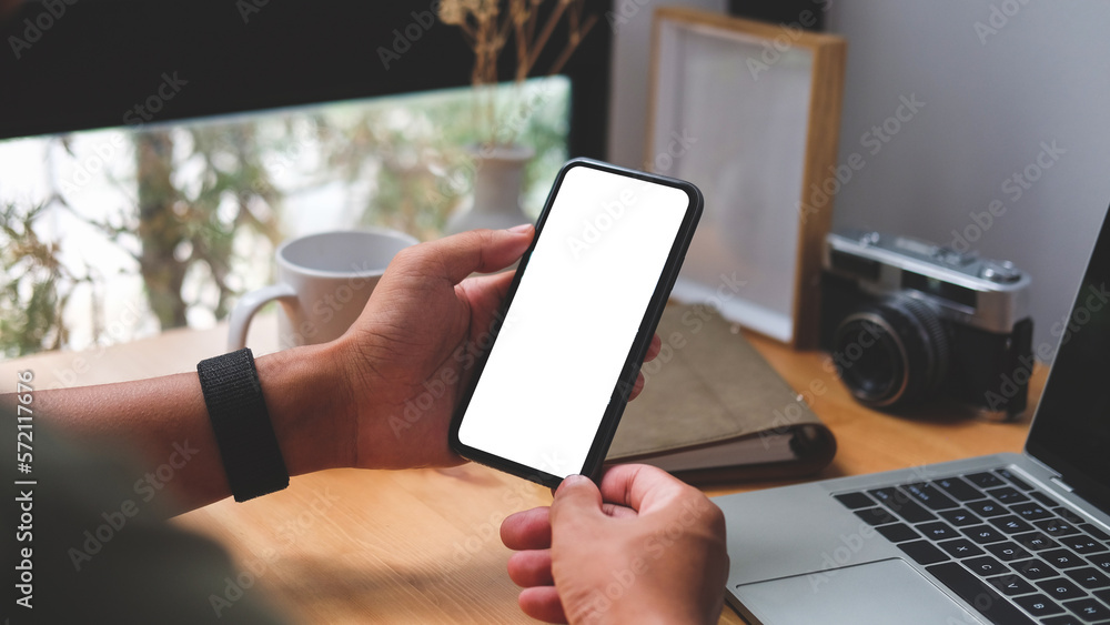 Poster view over shoulder of man hands holding smart phone. empty screen for your advertise text..