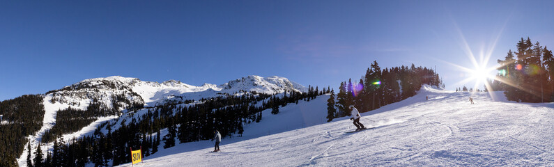 Fototapeta na wymiar Mountain peak and chair lift with skiers, winter landscape, ski resort, Whistler BC.