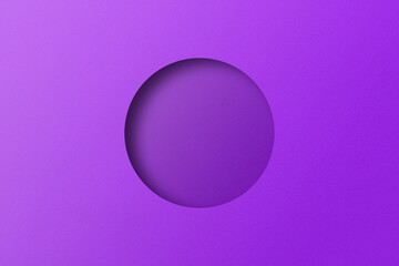 Purple paper cut into circular holes stacked together with light and shadow.
