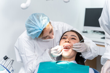 Caucasian dentist examine tooth for young girl at dental health clinic