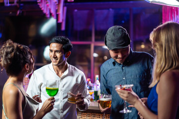Group of multiethnic friends having fun, dancing with music in a bar.