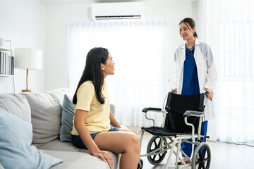 Asian caregiver nurse support female leg amputee sitting on wheelchair