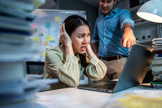 Asian frustrated businesswoman following direction from boss in office