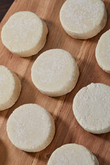 raw cottage cheese pancakes on the wooden board