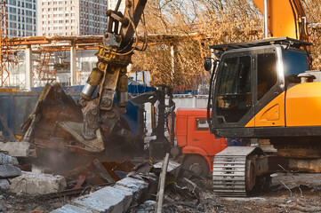 Fototapeta premium Excavator destroyer removes debris winter day