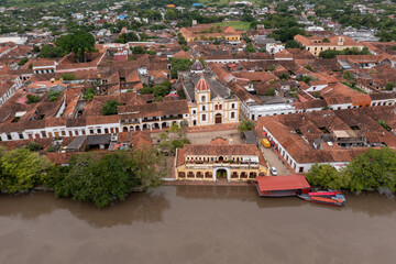 Aerial view of the main square of the town of Santa Cruz de Mompox and the port building on the banks of the Magdalena river. Bolivar Department .Colombia - obrazy, fototapety, plakaty