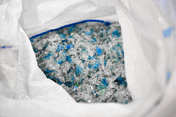Chopped pieces of plastic made of recycled waste plastic in open sack