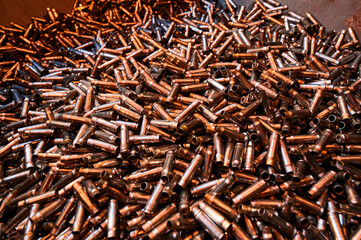 Bullet casings pile in weapon production plant storage