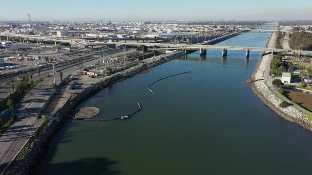 Afternoon aerial view of the mouth of the Los Angeles River as it meets the Pacific Ocean in Long Beach, California, USA.