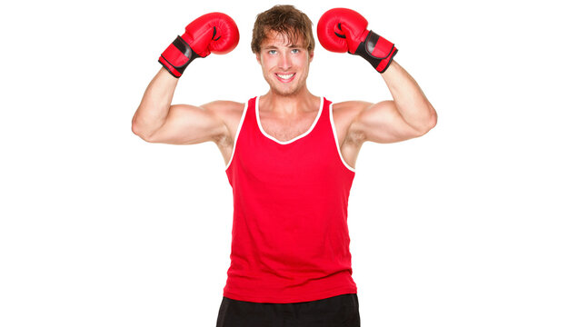 Fitness boxing man showing strength flexing muscles. Handsome strong fit boxer smiling happy wearing red boxing gloves isolated cutout PNG on transparent background.