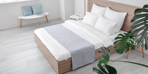 Big comfortable bed in light hotel room
