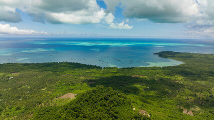 Fototapeta na wymiar Aerial view of island with jungle and blue sea. Seascape in the tropics. Balabac, Palawan. Philippines.