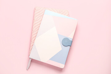 Stylish notebooks on pink background