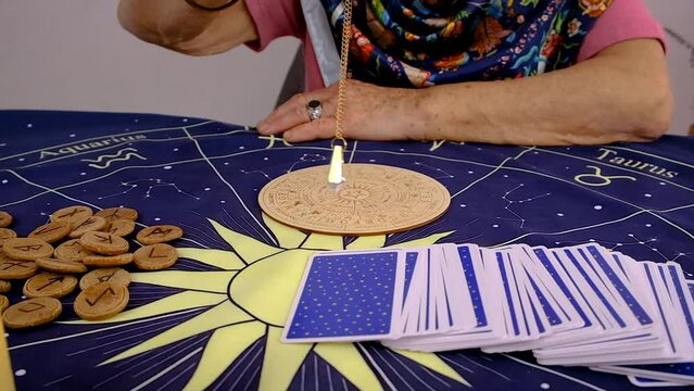 Fortune teller woman reads tarot cards. Selective focus.