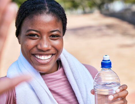 Fitness, selfie portrait and black woman with water for hydration after exercise outdoors. Workout, sports training and face of happy female athlete taking pictures or photo for social media memory.