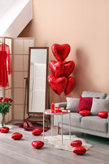 Interior of living room decorated for Valentine's Day with candles, gifts and balloons